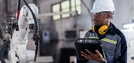 A person wearing hardhats and holding a tablet 